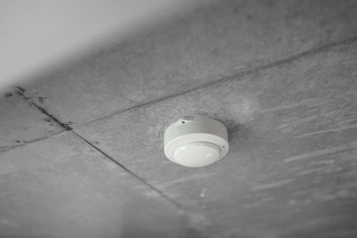 Smoke detector on a concrete ceiling, serviced under BS 5839-1