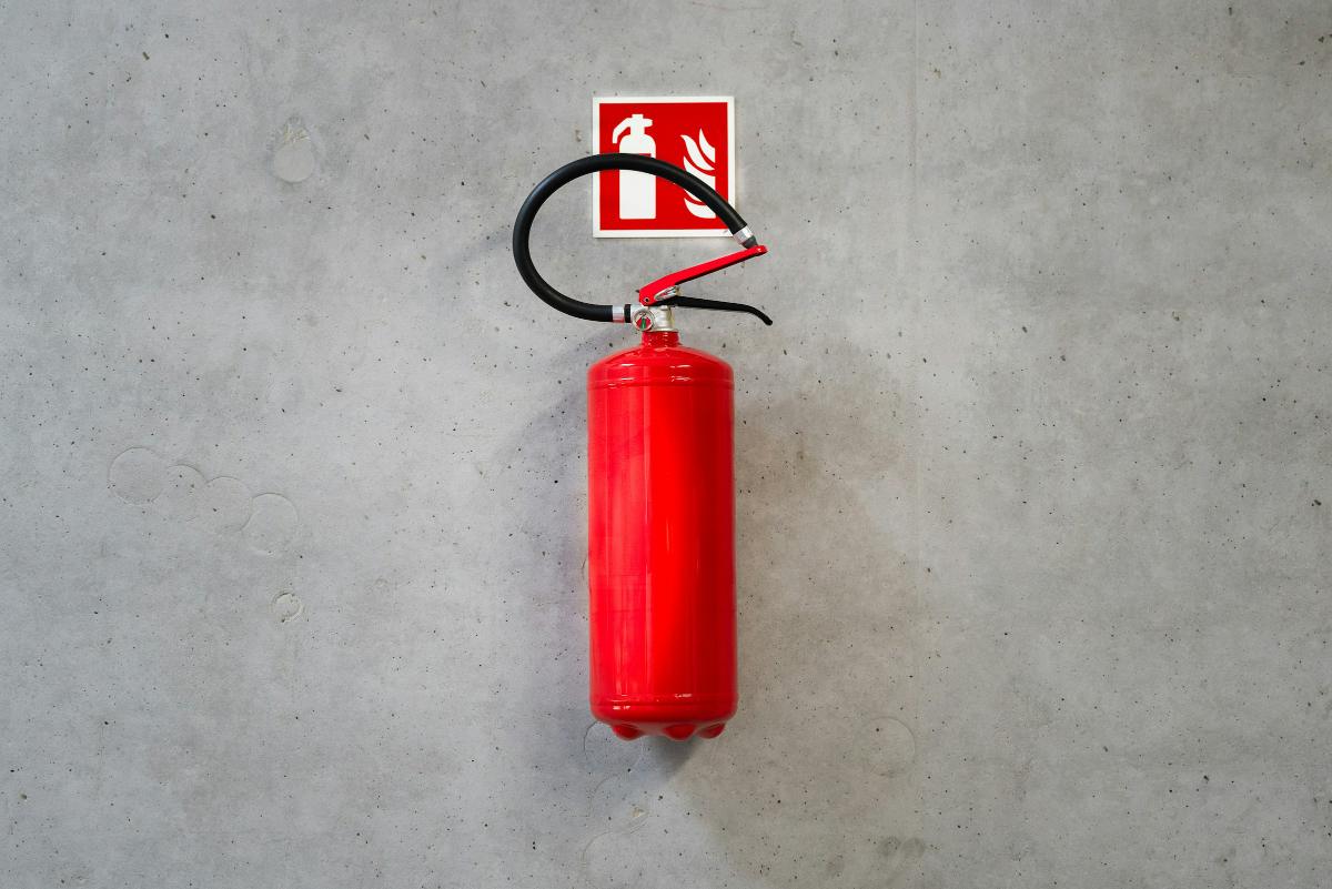 Wall-mounted fire extinguisher with signage
